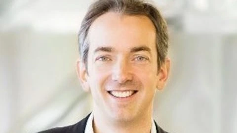 Portrait of Max Koeune smiling in a business setting
