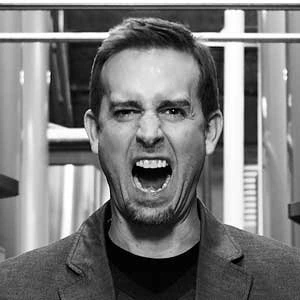 Greg Koch, co-founder and former CEO of Stone Brewing, shouting in a black-and-white portrait inside a brewery setting.